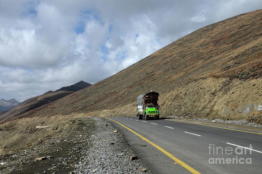 Green goods truck on Karakoram Highway amid mountains Babusar Pass Pakistan #3 Photograph by Imran Ahmed