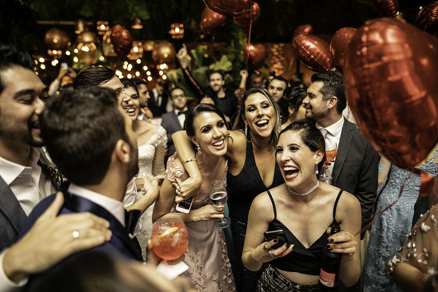 Groom and wedding guests laughing during party #1 Photograph by FG Trade