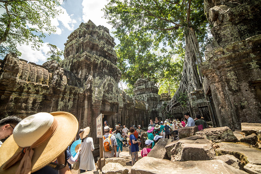 Group of tourist  visiting the Ta Prohm temple, Angkor, Cambodia #1 Photograph by Swissmediavision