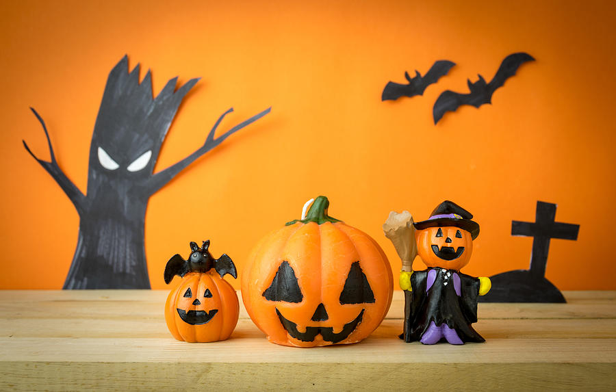 Halloween Pumpkins on wooden table #1 Photograph by Zenstock