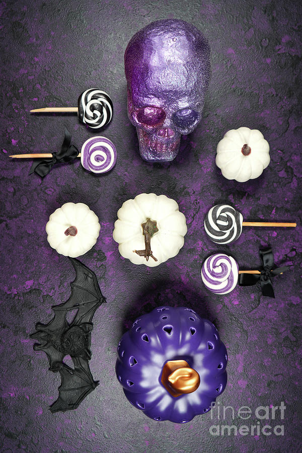 Halloween trick or treat flatlay on purple background with skull and pumpkins. #1 Photograph by Milleflore Images
