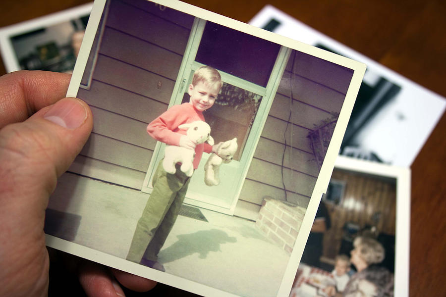 Hand holds Vintage photograph of child during summer #1 Photograph by Catscandotcom