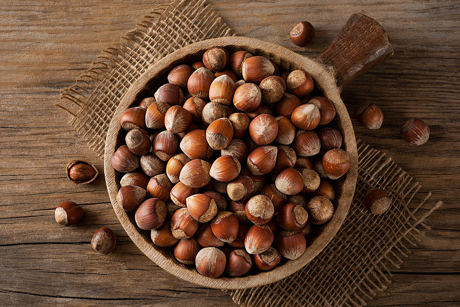 Hazelnuts in a wooden bowl #1 Photograph by Burcu Atalay Tankut