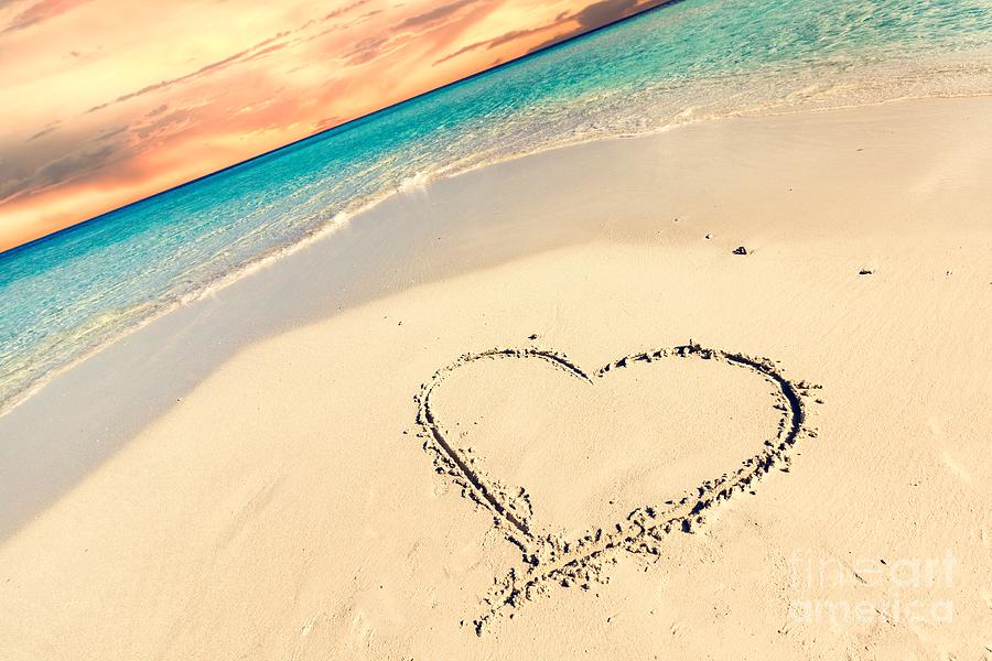 Heart on sand on tropical beach at sunset. #1 Photograph by Michal Bednarek
