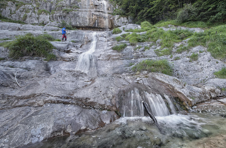 Hiker at Königsbach waterfall in Berchtesgaden National Park #1 Photograph by DieterMeyrl