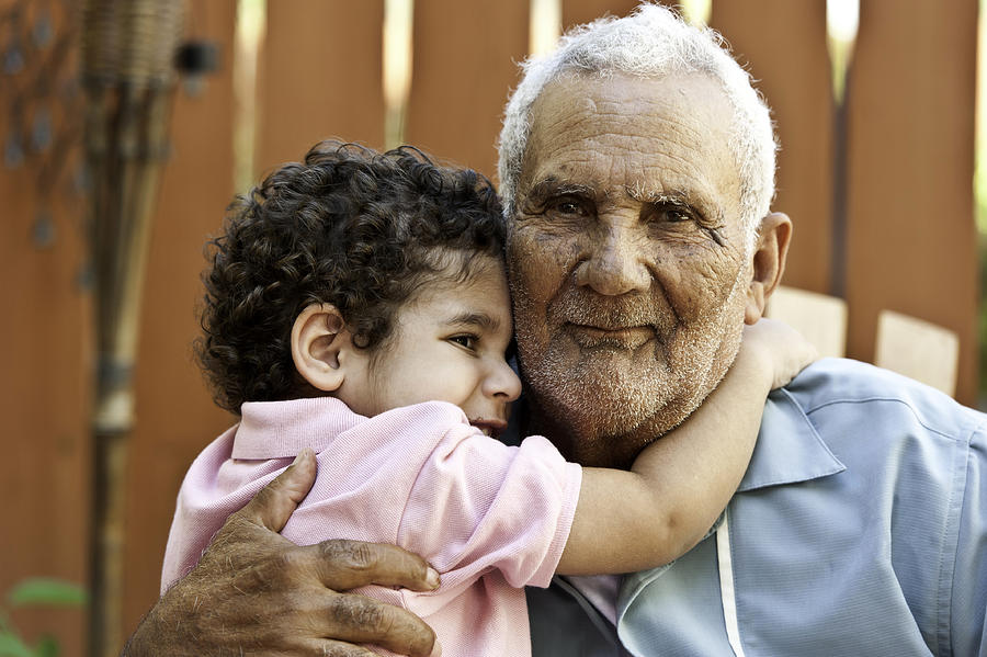 Hispanic grandfather with his grandson #1 Photograph by Juanmonino