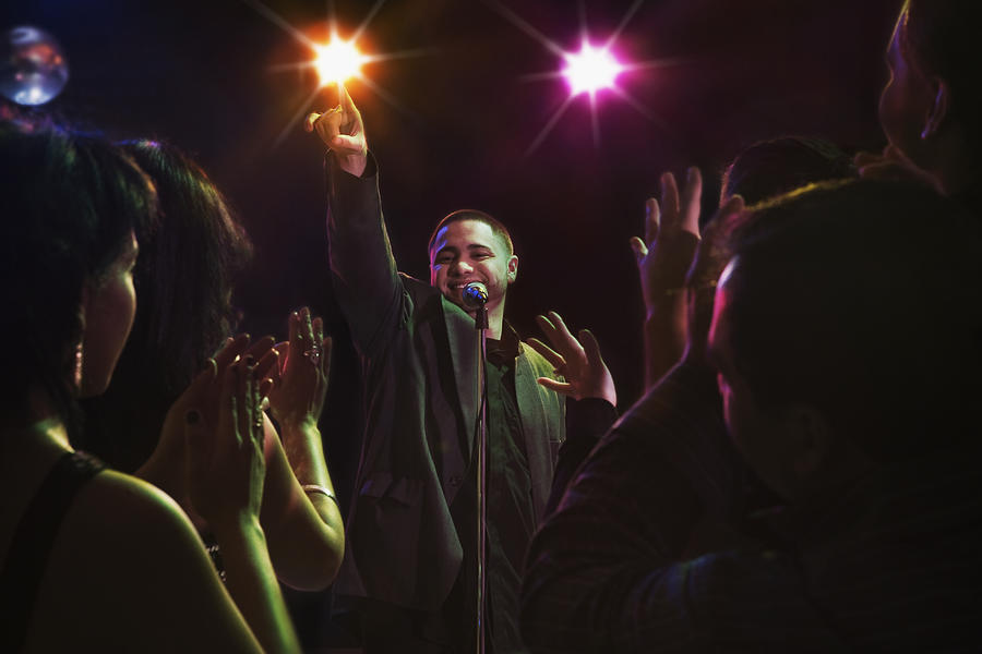Hispanic man singing in nightclub #1 Photograph by Jose Luis Pelaez Inc