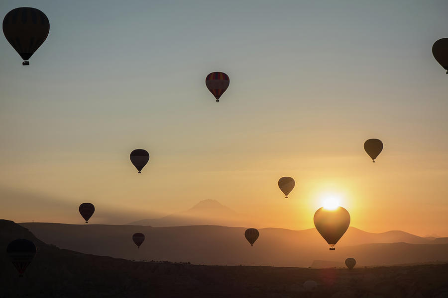Hot Air Balloons In The Sky During Sunrise. Flying Over The Valley At Cappadocia, Anatolia, Turkey. Volcanic Mountains In Goreme National Park. Photograph