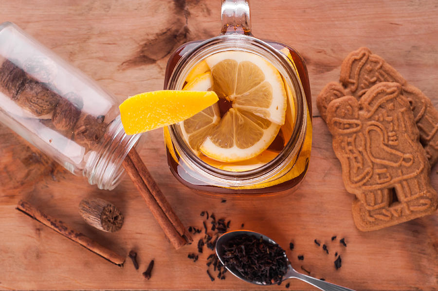 Hot spiced tea in jar on wooden table #1 Photograph by MichalDziedziak