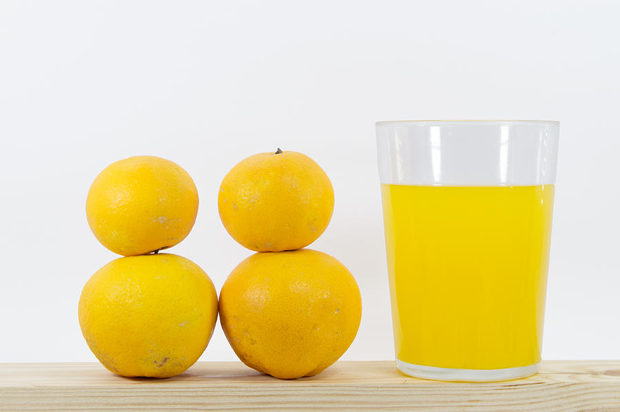 How many oranges do you need to make a glass of orange juice? #1 Photograph by Luis Diaz Devesa