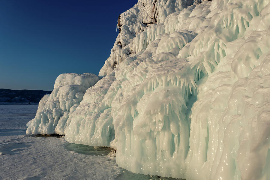 Ice and icicles on rocks on Lake Baikal #1 Photograph by Mikhail Kokhanchikov