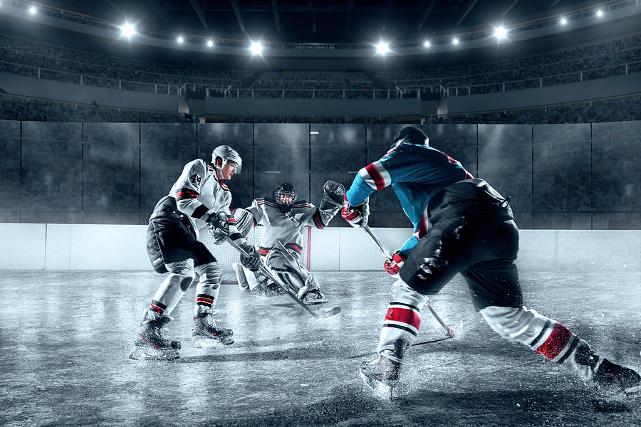 Ice hockey players on big professional ice arena #1 Photograph by Aksonov
