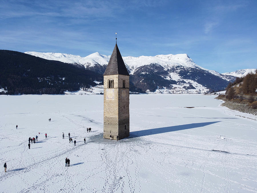 Il campanile sommerso del lago di Resia con la neve #1 Photograph by Pietro Ebner