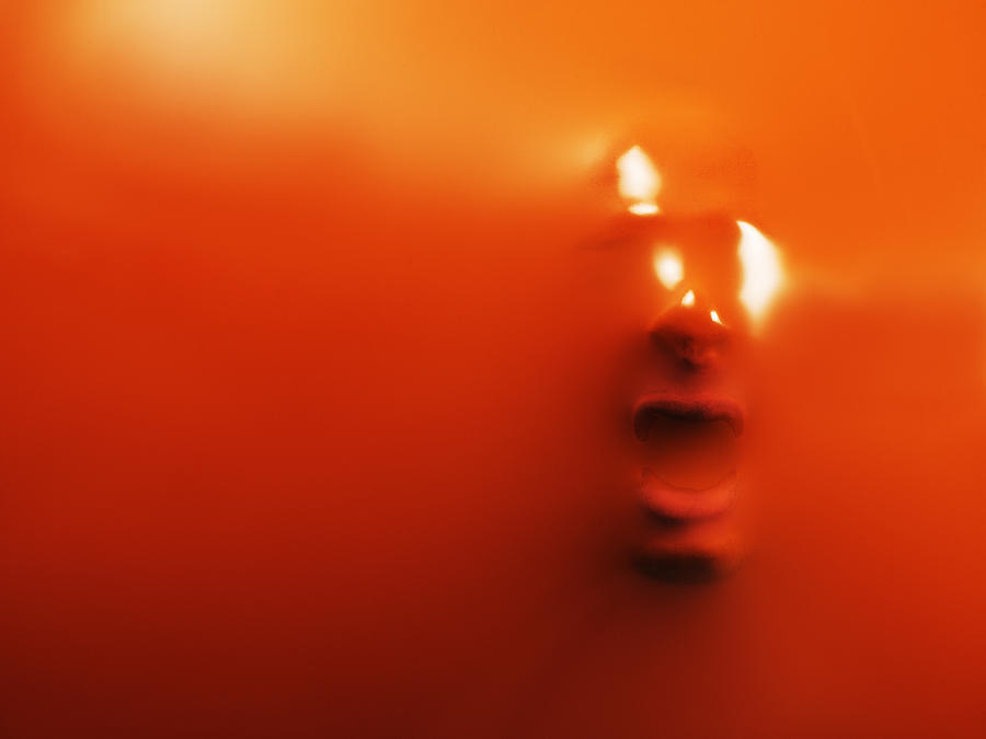 Impression of mans face through orange rubber, close-up #1 Photograph by Henrik Sorensen