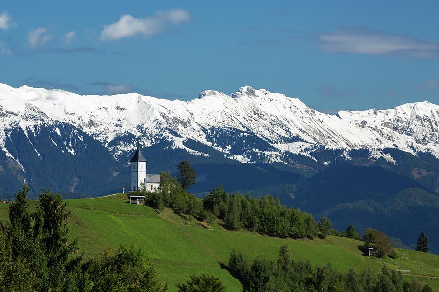 Jamnik church with Karavanke Alps backdrop #1 Photograph by Ian Middleton