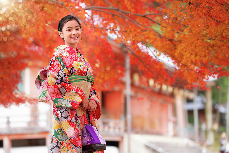 Japanese tourist girl in red Kimono traditional dress walking in #1 Photograph by Anek Suwannaphoom