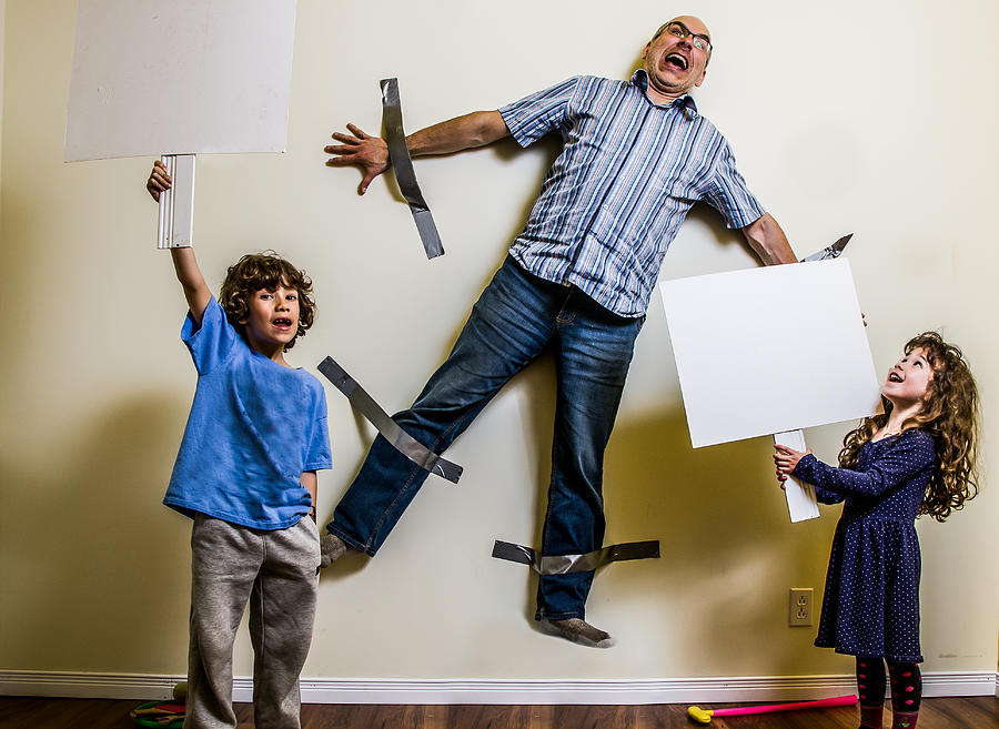 Kids rebellion led to strapping the father on wall #1 Photograph by Marcduf