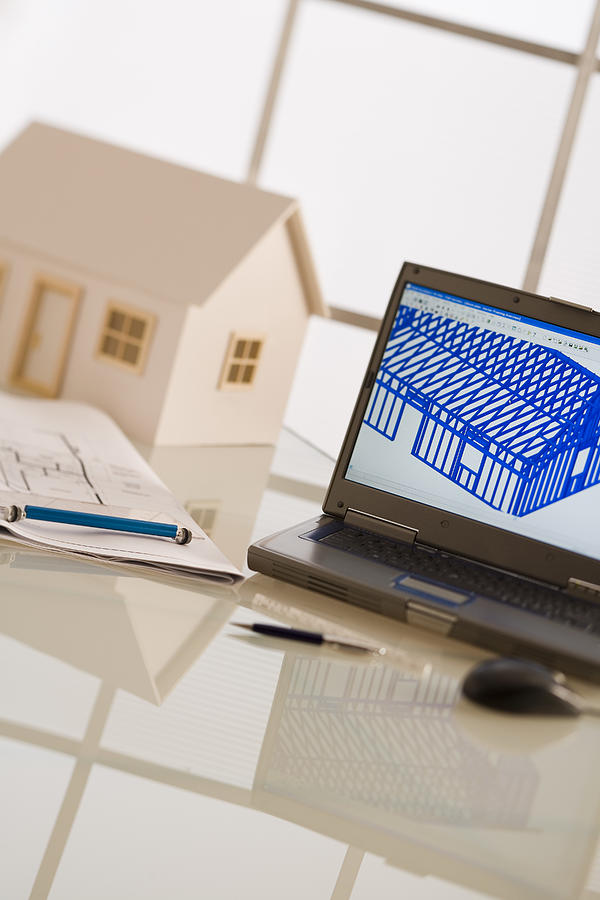 Laptop, model house, and blueprints #1 Photograph by Comstock Images