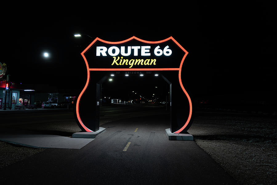 Large Route 66 sign in Kingman Arizona at night #1 Photograph by Eldon McGraw