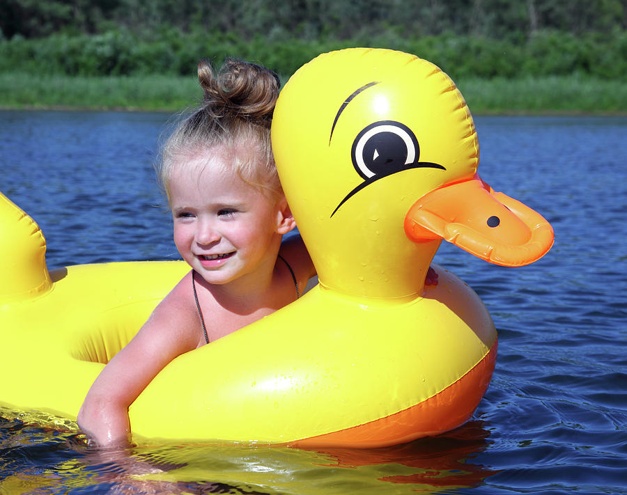 Little Girl Bathes In River In Inflatable Duck #1 Photograph by Mikhail Kokhanchikov