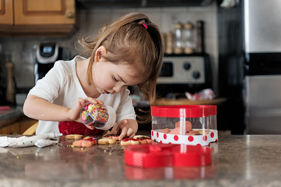 Little girl making valentine’s cookie #1 Photograph by Lise Gagne