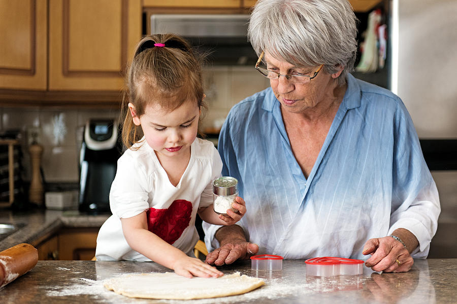 Little girl making valentine’s cookie with grandma #1 Photograph by Lise Gagne