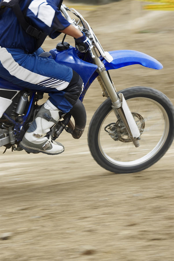 Low section view of a motocross rider riding a motorcycle #1 Photograph by Glowimages