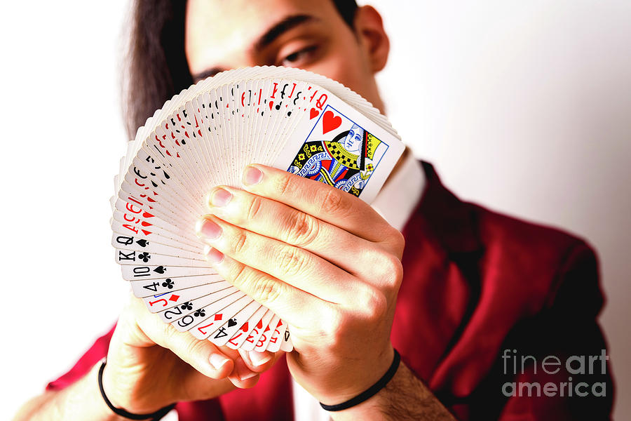 Magician Doing Tricks With A Deck Of Cards. #1 Photograph by Joaquin Corbalan