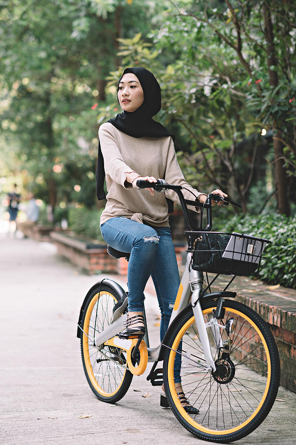 Malay Female Riding Her Bicycle #1 Photograph by Edwin Tan