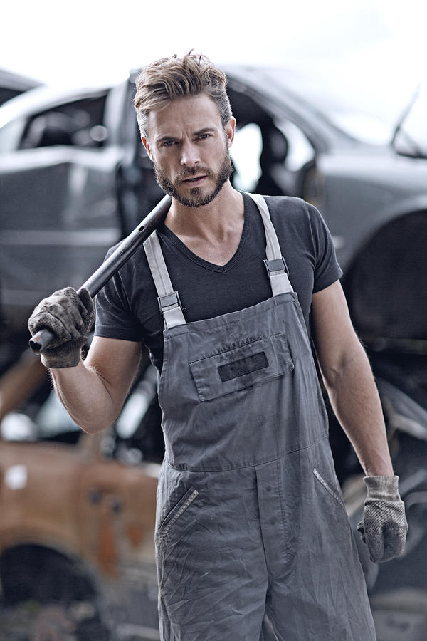 Male mechanic at junkyard #1 Photograph by Lorado
