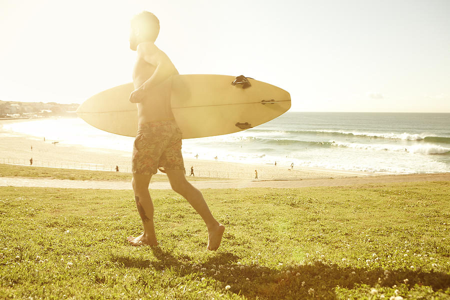 Male surfer in Bondi, Australia #1 Photograph by Stuart Ashley