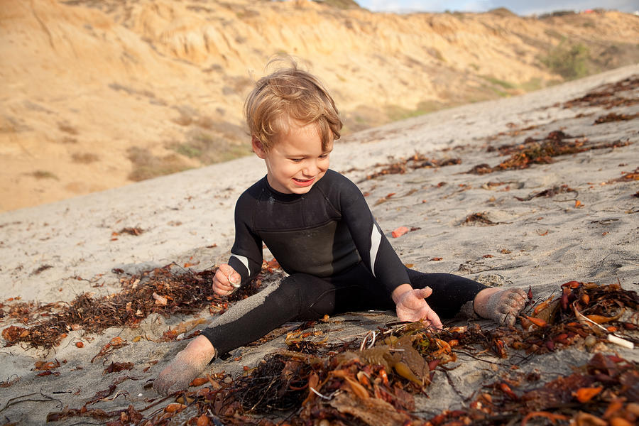 Male Toddler Playing On Southern California Beach In Wetsuit #1 Photograph by Surfin_Rox
