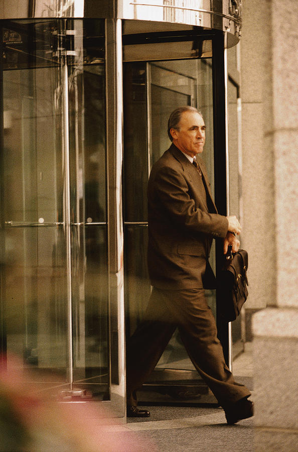 Man Exiting through Revolving Door #1 Photograph by Keith Brofsky