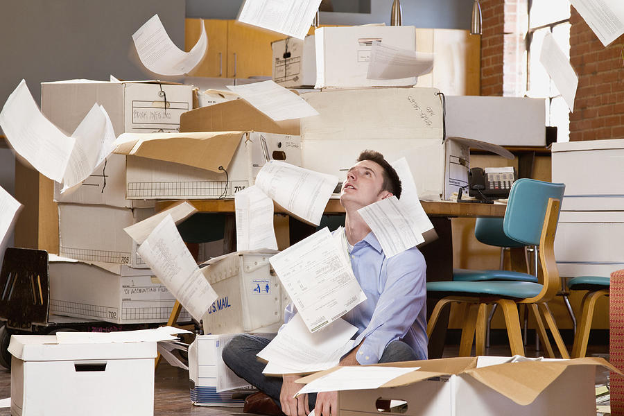 Man in an office over flowing with paperwork #1 Photograph by DreamPictures