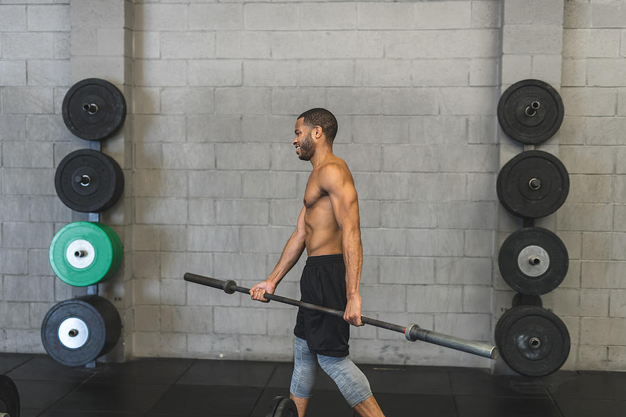 Man lifting weights at the gym #1 Photograph by FatCamera