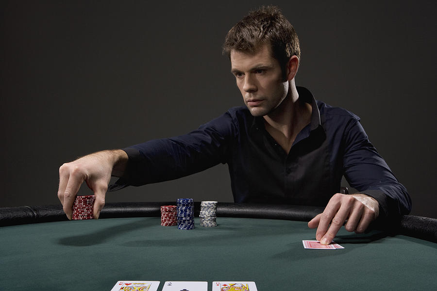 Man playing poker in casino #1 Photograph by Duncan Nicholls and Simon Webb