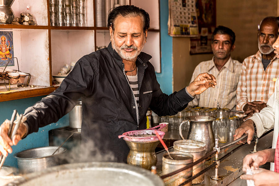 Man pours cup hot milk tea (Masala Chai) Indian style #1 Photograph by FG Trade