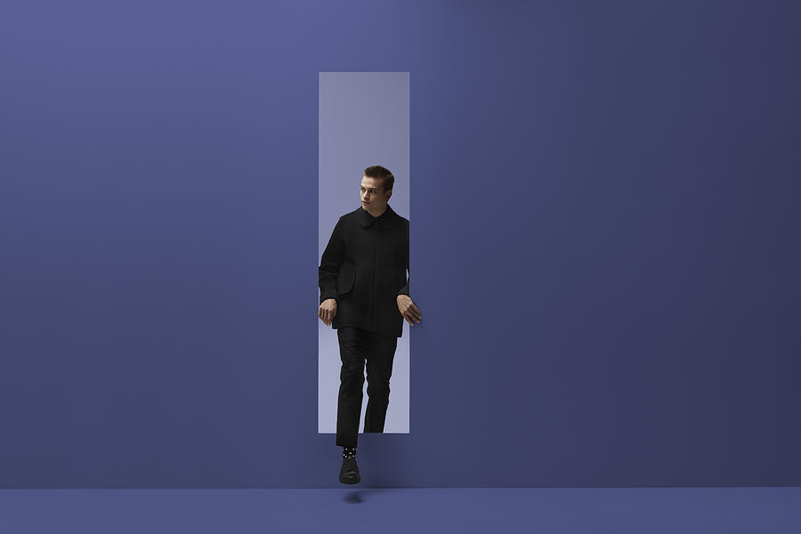 Man walking threw rectangular opening in coloured room #1 Photograph by Klaus Vedfelt