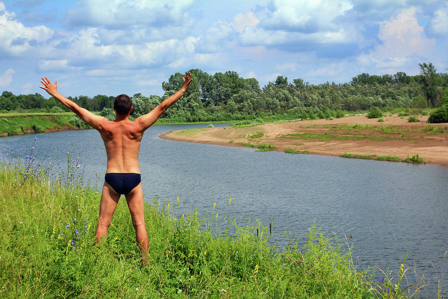 Man With Hands Up Near River #1 Photograph by Mikhail Kokhanchikov