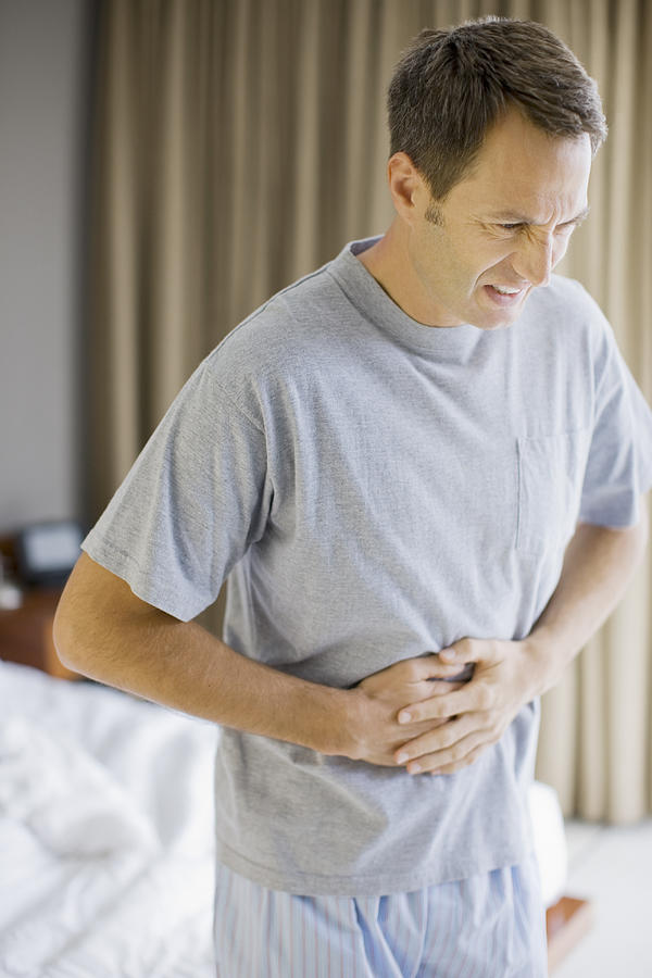 Man with stomachache #1 Photograph by Paul Bradbury