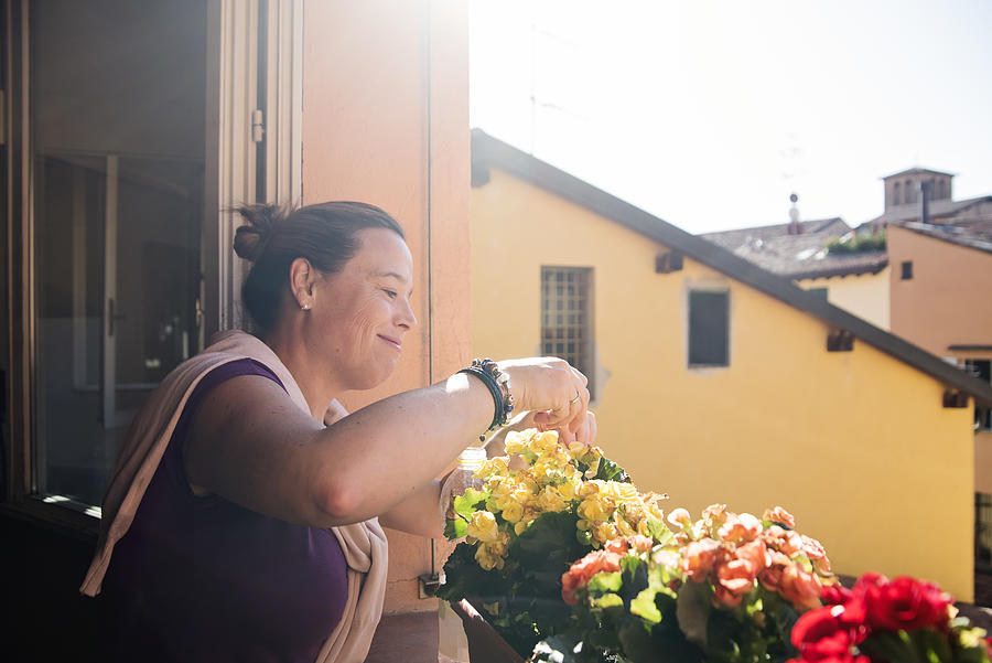 Mature woman gardening in her appartement. #1 Photograph by Martinedoucet