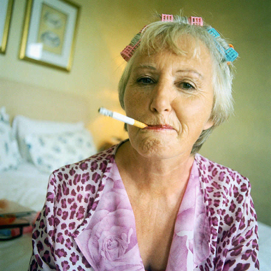 Mature woman smoking cigarette, portrait #1 Photograph by Patrick Sheandell OCarroll