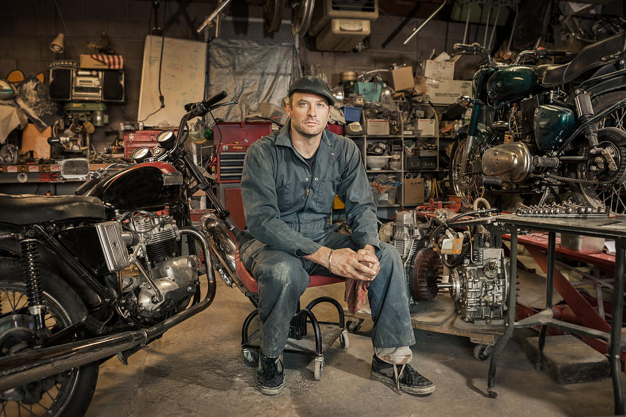 Mechanic in his garage converting gas powered motorcycles to Bio-Diesel #1 Photograph by Heshphoto