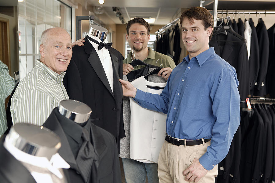 Men shopping for tuxedos #1 Photograph by Comstock Images