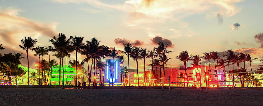 Miami Beach Ocean Drive panorama with hotels and restaurants at sunset. City skyline with palm trees at night. Art deco nightlife on South beach Photograph by Maria Kray Miami Beach Ocean Drive panorama with hotels and restaurants at sunset. City skyline with palm trees at night. Art deco nightlife on South beach Photograph by Maria Kray