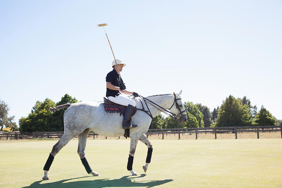 Mid adult man playing polo #1 Photograph by Axel Bernstorff