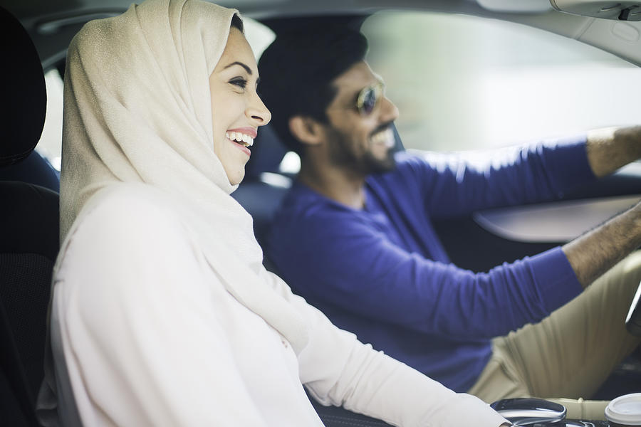 Middle eastern couple driving a luxury car in Dubai #1 Photograph by Tempura