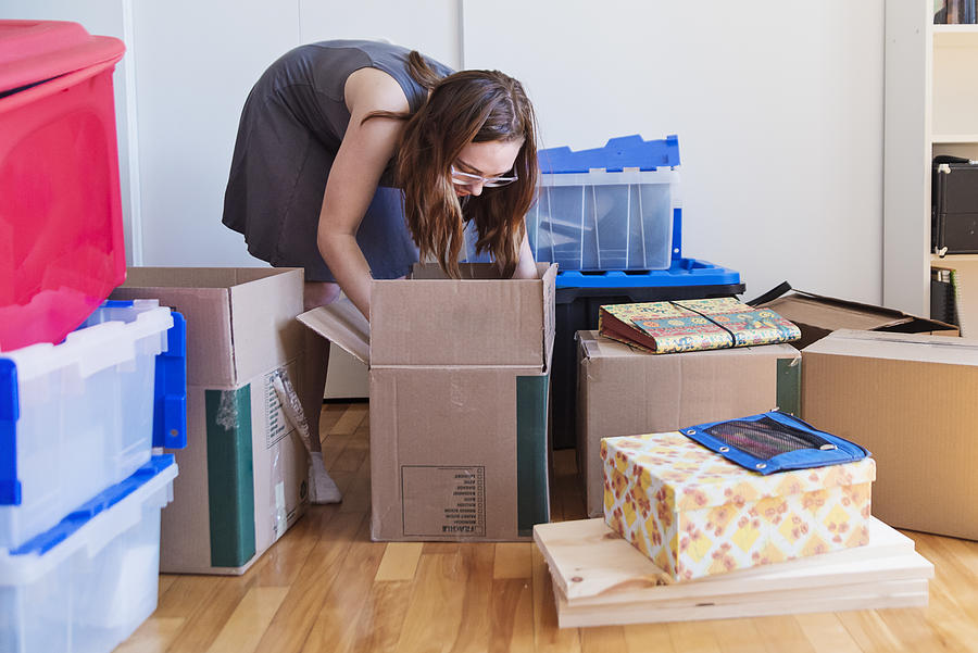Millennial young woman moving in new apartment. #1 Photograph by Martinedoucet