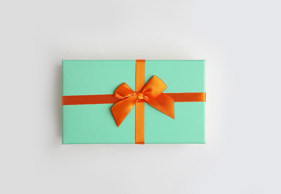 Mint color gift box with orange ribbon on white background. Isolate, copy space. #1 Photograph by Yulia Naumenko