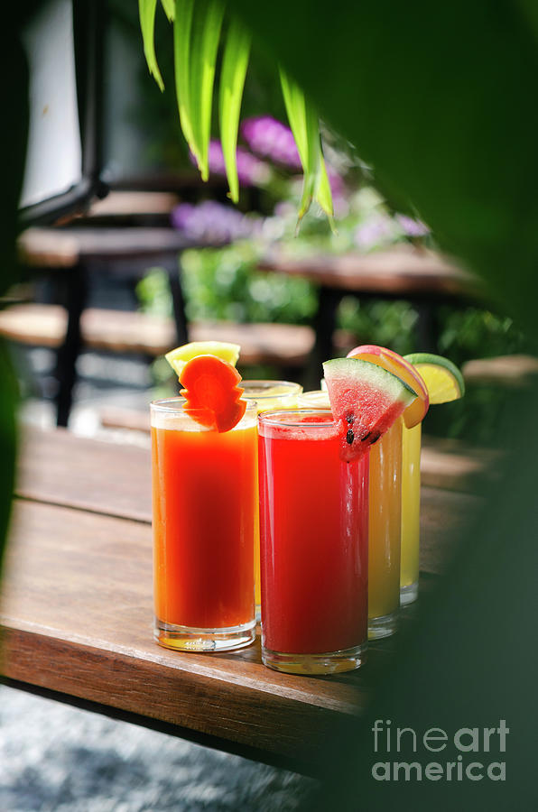 Mixed Fresh Organic Fruit Juices Glasses On Sunny Garden Table #1 Photograph by JM Travel Photography